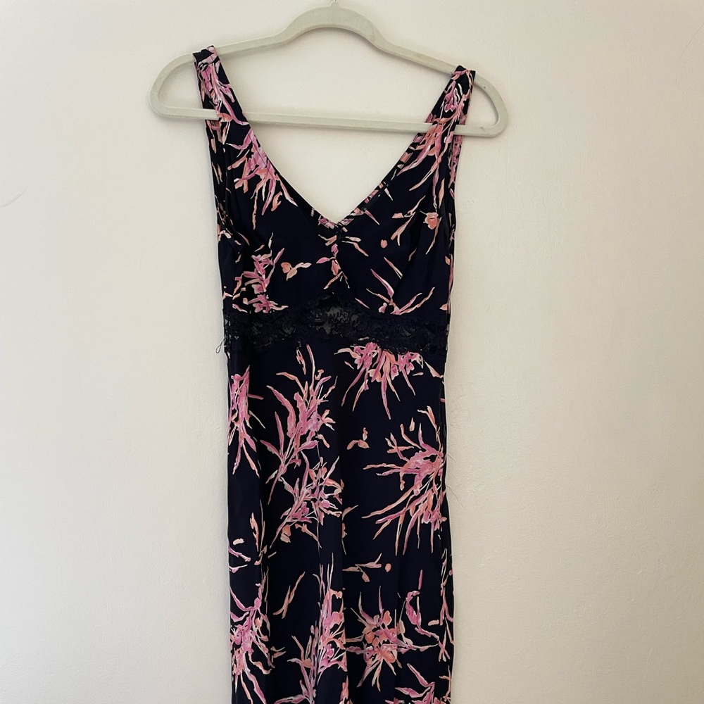 Black sleeveless floral bebe dress with lace trim and lace panel